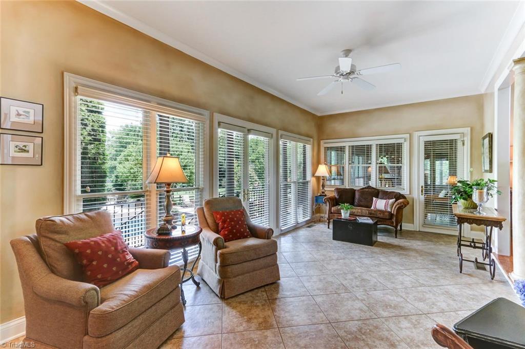 6310 Hunt Road Pleasant Garden, NC 27313 - Photo 14 of 30 One of two sunrooms. This wall of windows overlooks the backyard oasis. Double doors open to grilling deck with easy access to adjoining kitchen and great room bringing the outside in!