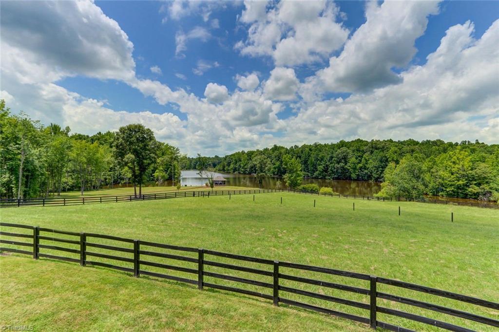 6310 Hunt Road Pleasant Garden, NC 27313 - Photo 24 of 30 Room for your four legged friends! Even the horses enjoy spectacular sunset and lakeviews! Several pastures with four board fencing. Ten acres of open land adjoins just under 30 acres of woods. Trail riding opportunities!