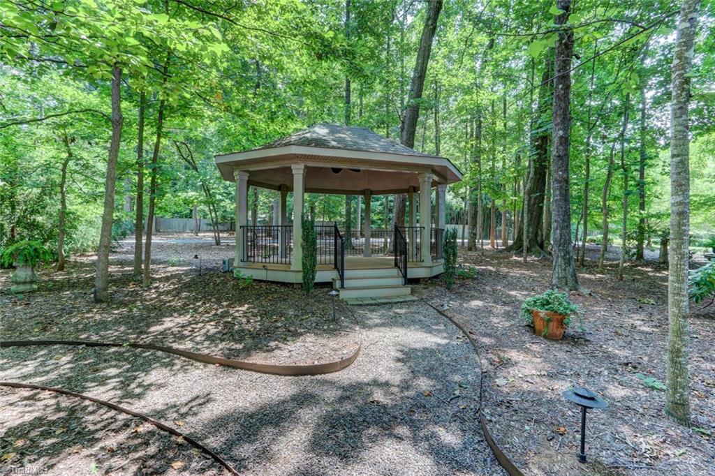 6310 Hunt Road Pleasant Garden, NC 27313 - Photo 27 of 30 The wedding gazebo! Can't you picture it! Lights for evening ambiance. Winding natural paths through the immaculately maintained woods, lead from the gazebo to a clearing with a firepit. Meander from one special spot to another!