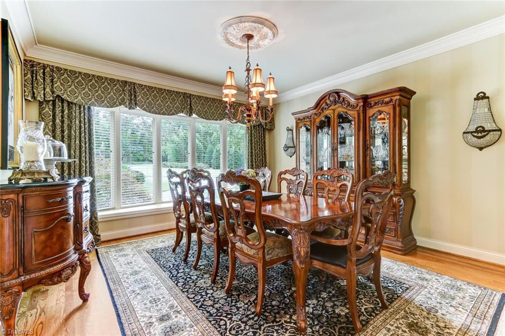 6310 Hunt Road Pleasant Garden, NC 27313 - Photo 8 of 30 Exquisite dining room detail. Casement bay windows with oversized sill, crown molding and decorative ceiling medallion. Comfortable size for large formal gatherings.