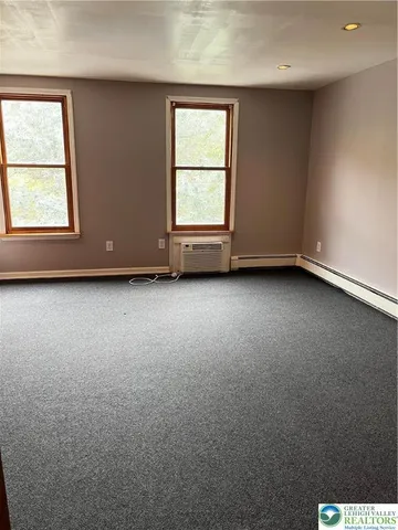 a bathroom with a glass shower door