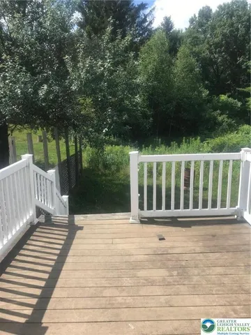 a view of outdoor space with deck and yard