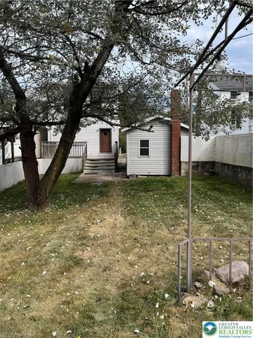a house with trees in the background