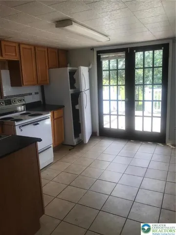 a kitchen with stainless steel appliances a refrigerator and a stove top oven