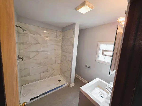 a bathroom with a shower and a sink