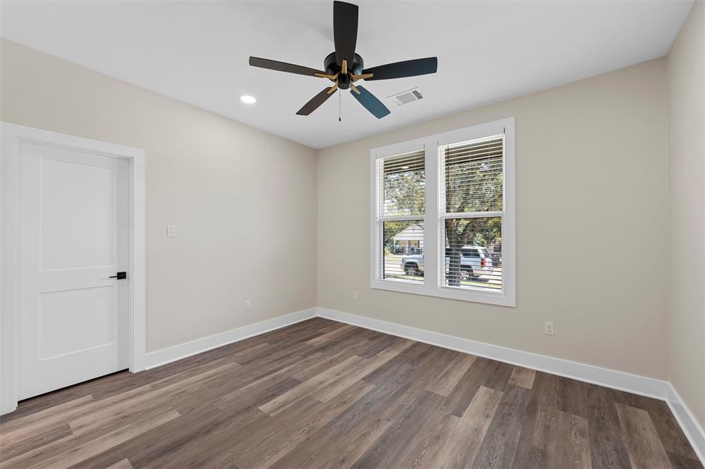 2923 Reuter Avenue Waco, TX 76708 - Photo 12 of 34 wooden floor in an empty room with a window