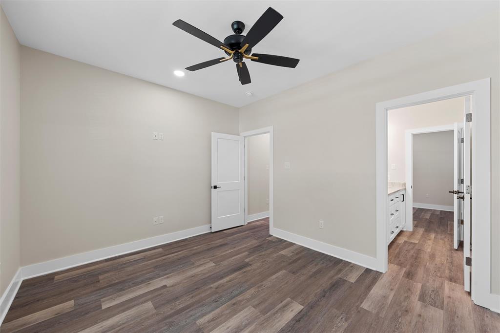 2923 Reuter Avenue Waco, TX 76708 - Photo 13 of 34 an empty room with wooden floor and a ceiling fan