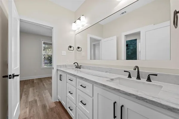 a bathroom with a double vanity sink and mirror