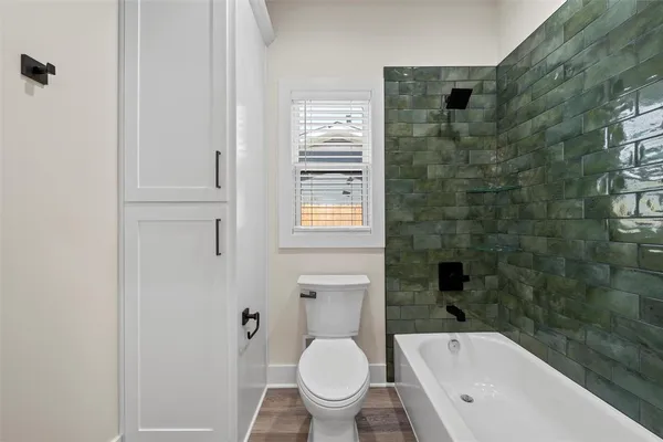a bathroom with a granite countertop toilet a sink and bathtub
