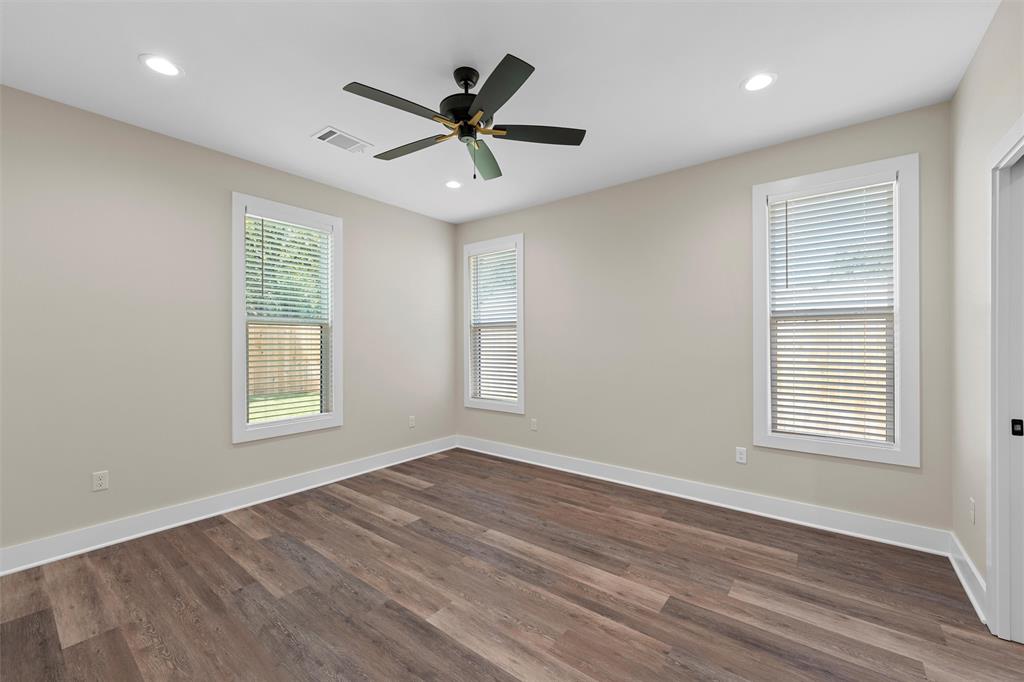 2923 Reuter Avenue Waco, TX 76708 - Photo 19 of 34 a view of an empty room with wooden floor and a window
