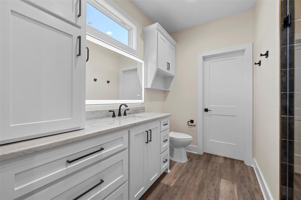 2923 Reuter Avenue Waco, TX 76708 - Photo 22 of 34 a bathroom with a granite countertop sink toilet and shower