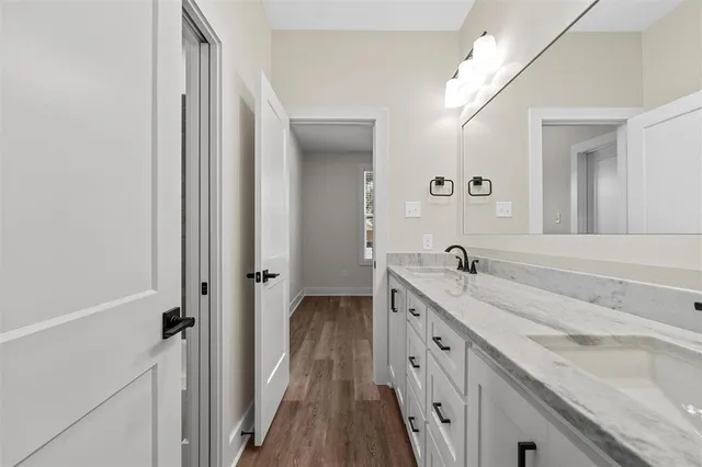 a spacious bathroom with a double vanity sink and mirror