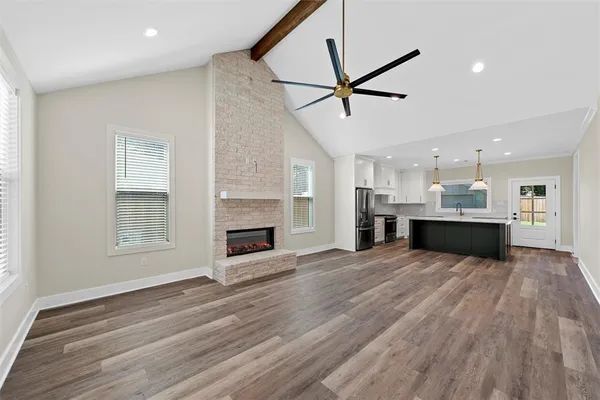 a view of kitchen and hall with wooden floor