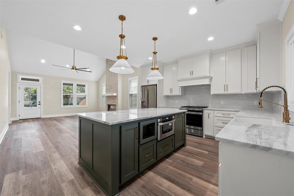 2923 Reuter Avenue Waco, TX 76708 - Photo 10 of 34 a kitchen with stainless steel appliances granite countertop a sink a stove and a wooden floors