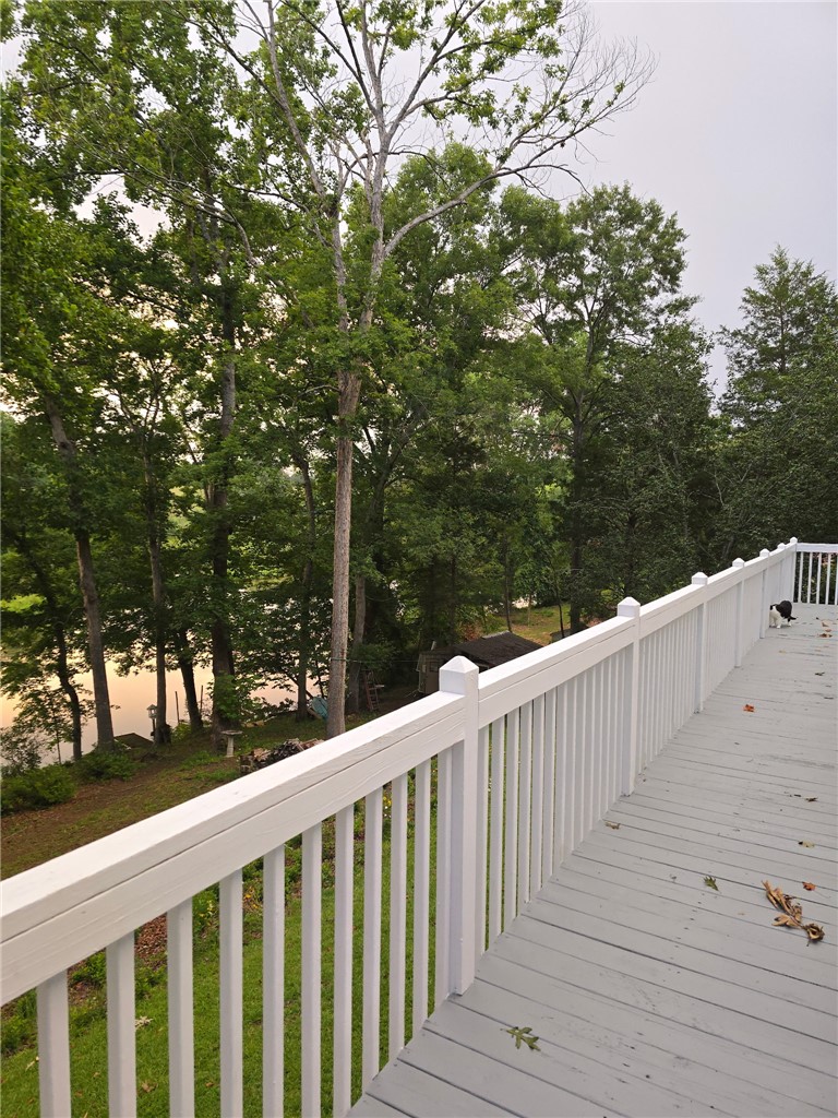 418 Saluda Road Williamston, SC 29697 - Photo 8 of 43 Perched above a serene lake, this extensive deck offers peaceful waterside relaxation.