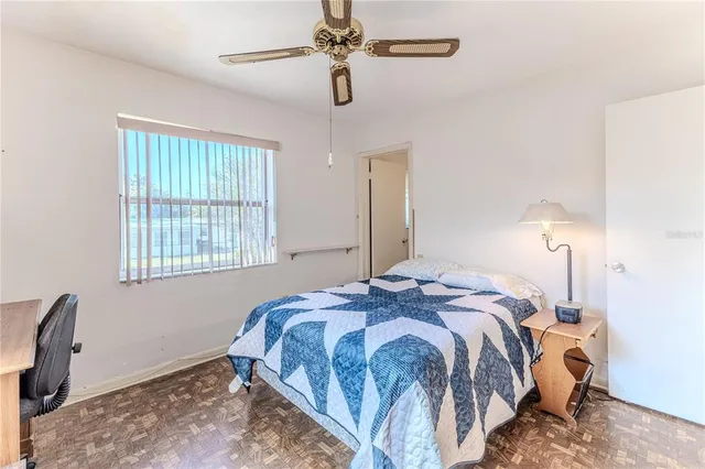 a bedroom with a bed and a window