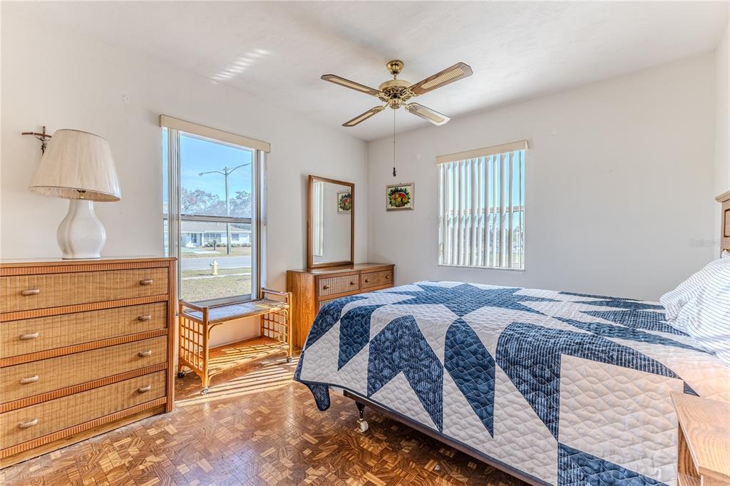 6352 Spring Hill Drive Spring Hill, FL 34606 - Photo 20 of 35 a bedroom with a bed and wooden floor