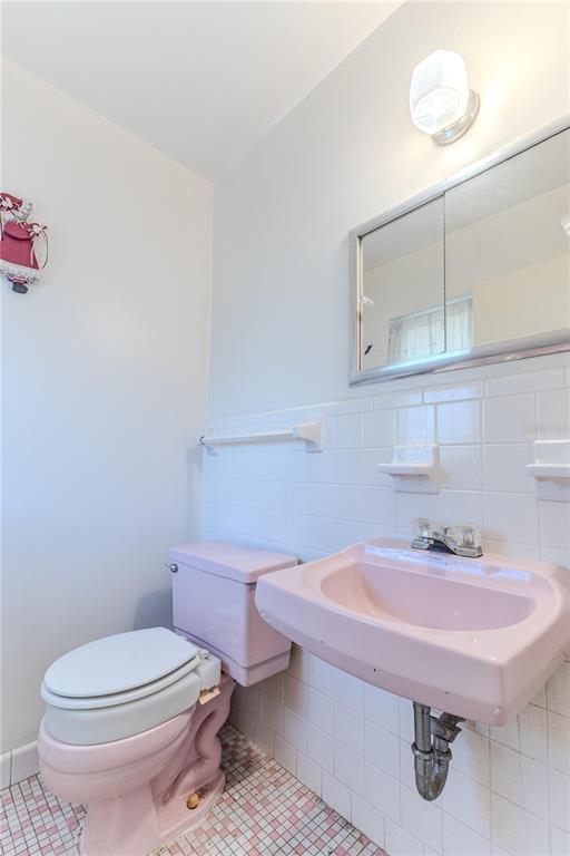 6352 Spring Hill Drive Spring Hill, FL 34606 - Photo 24 of 35 a bathroom with a sink a toilet and mirror