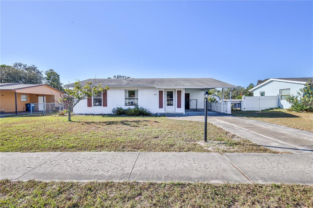 6352 Spring Hill Drive Spring Hill, FL 34606 - Photo 5 of 35 a front view of a house with garden