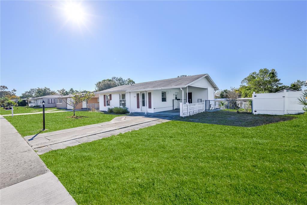 6352 Spring Hill Drive Spring Hill, FL 34606 - Photo 6 of 35 a view of house with a big yard and large trees