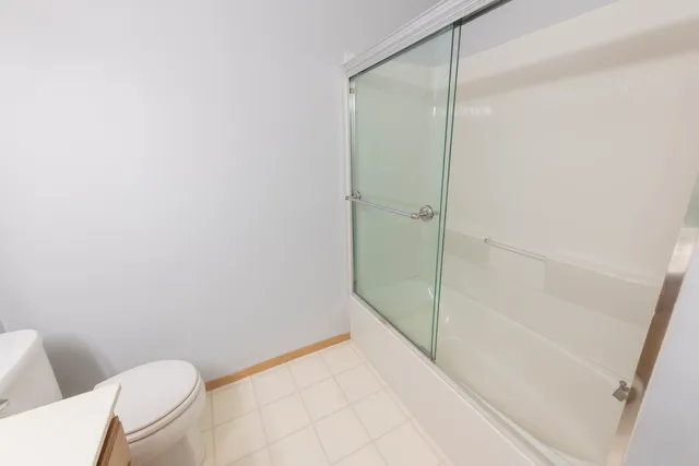 a bathroom with a shower and toilet