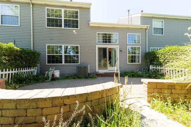 a view of a house with a small yard and plants