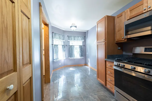 a view of kitchen with wooden floor electronic appliances and window