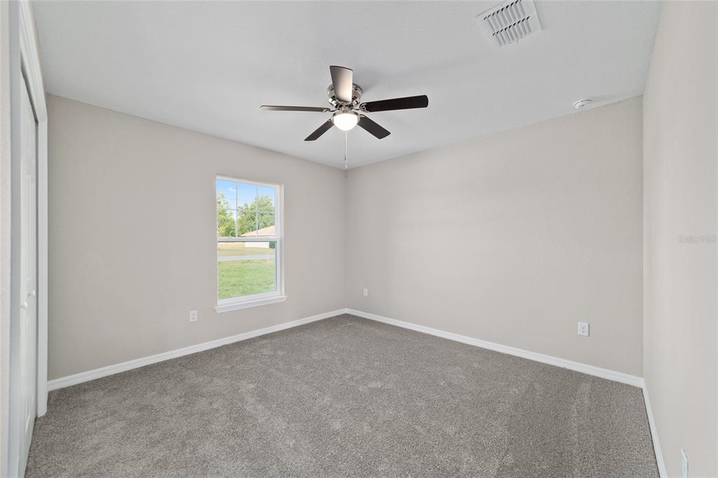 19231 Southwest 97th Street Dunnellon, FL 34432 - Photo 16 of 31 an empty room with a window and a fan