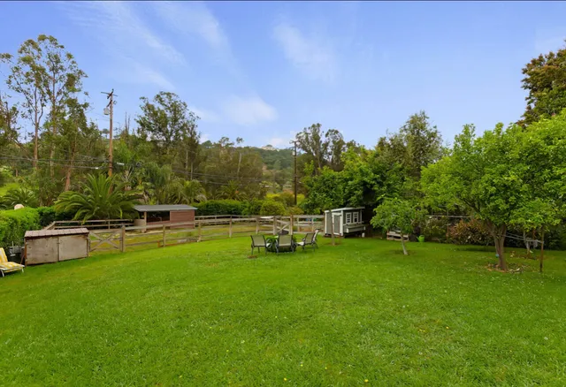 a view of a swimming pool with a yard