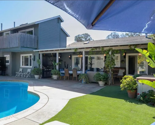 a view of a house with swimming pool and porch