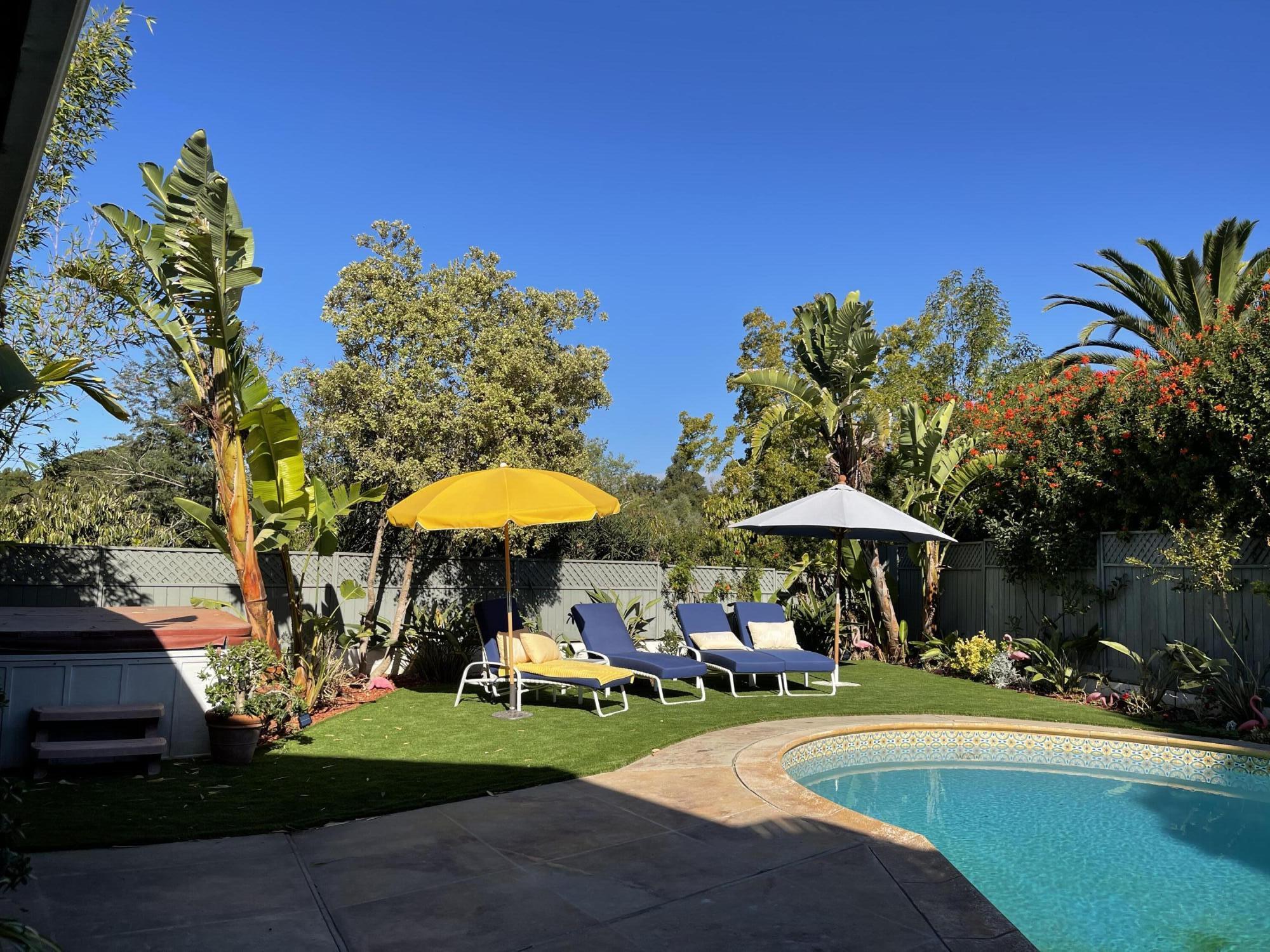4156 Vista Clara Road Santa Barbara, CA 93110 - Photo 34 of 36 a view of a swimming pool with lawn chairs under an umbrella