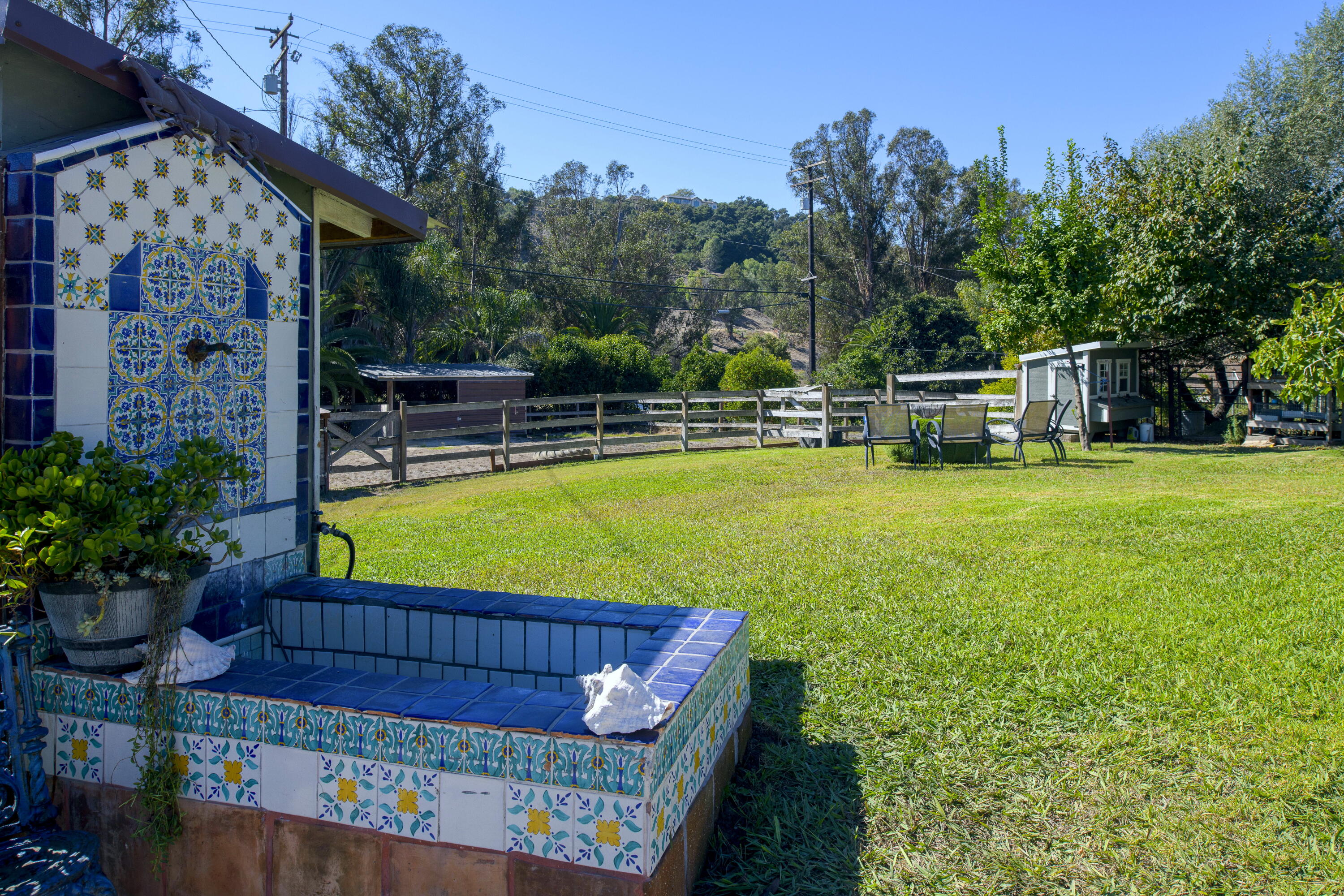 4156 Vista Clara Road Santa Barbara, CA 93110 - Photo 35 of 36 a view of a swimming pool with a bench and trees in the background