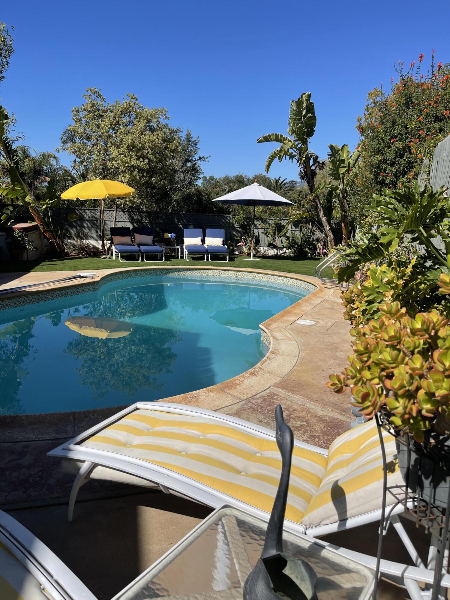 4156 Vista Clara Road Santa Barbara, CA 93110 - Photo 6 of 36 a view of a swimming pool with lawn chairs under an umbrella
