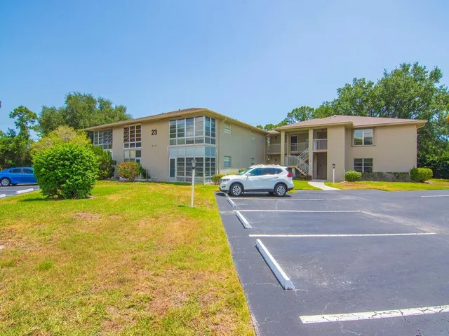 a front view of house with yard and swimming pool