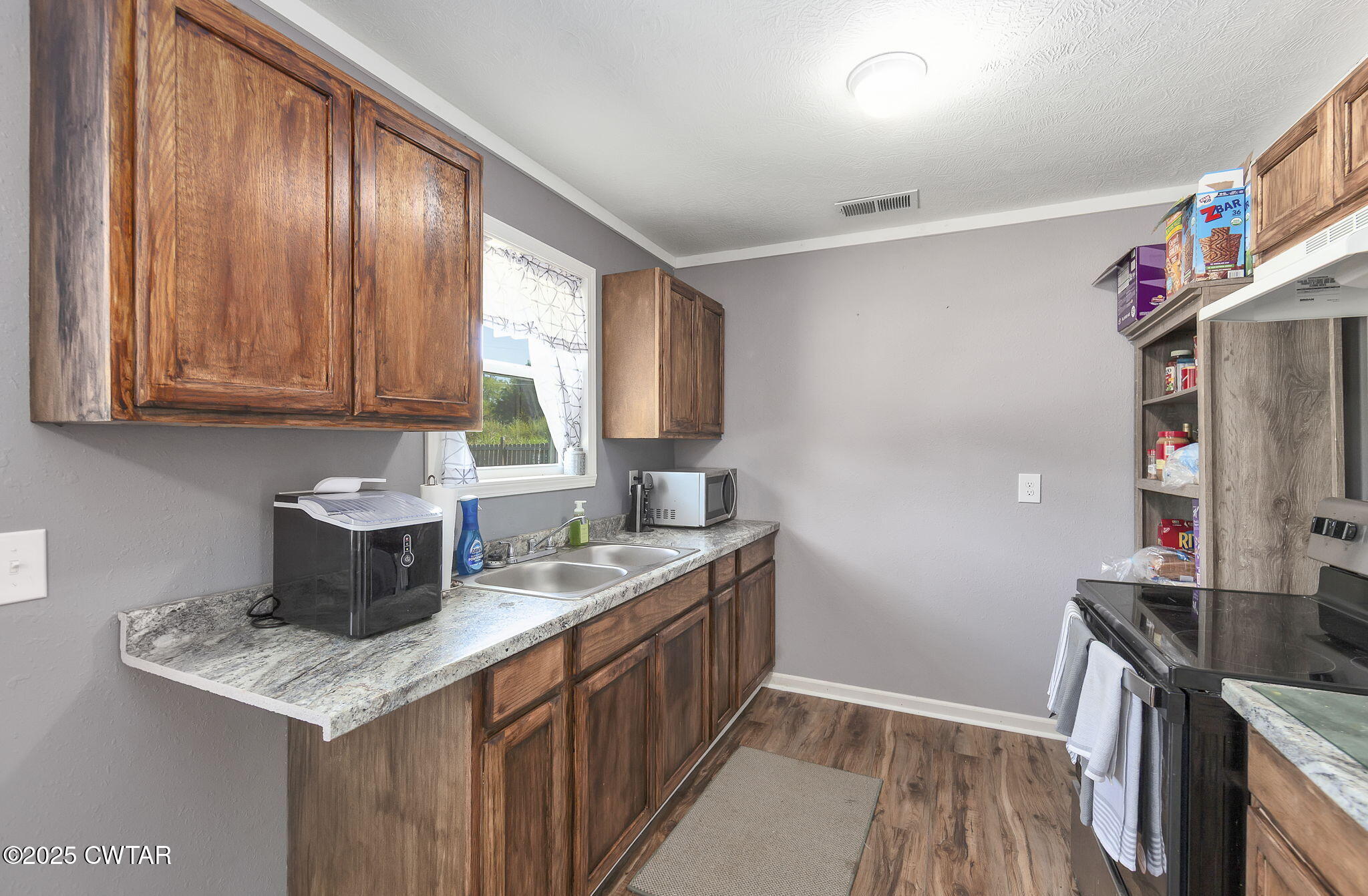 668 Bowman Road Medon, TN 38356 - Photo 11 of 24 a kitchen with stainless steel appliances granite countertop a sink stove and cabinets