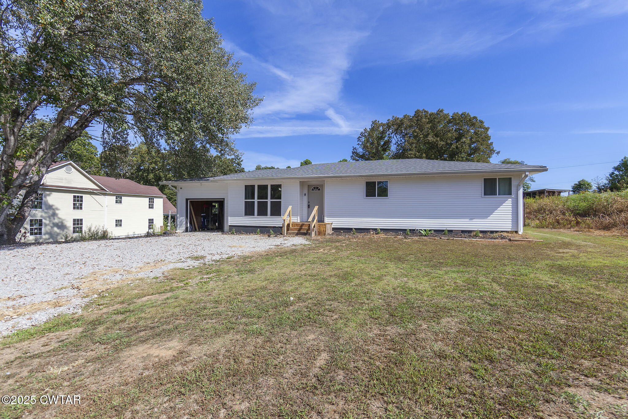 668 Bowman Road Medon, TN 38356 - Photo 2 of 24 a front view of a house with a yard and garage