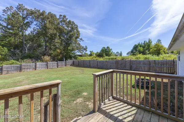 a view of a deck with a big yard