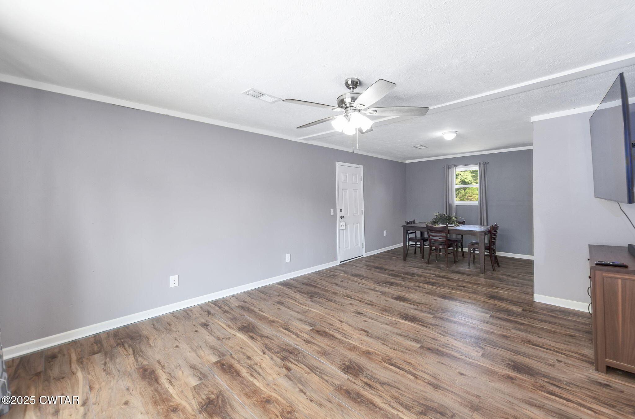 668 Bowman Road Medon, TN 38356 - Photo 6 of 24 a view of a livingroom with a chair and wooden floor