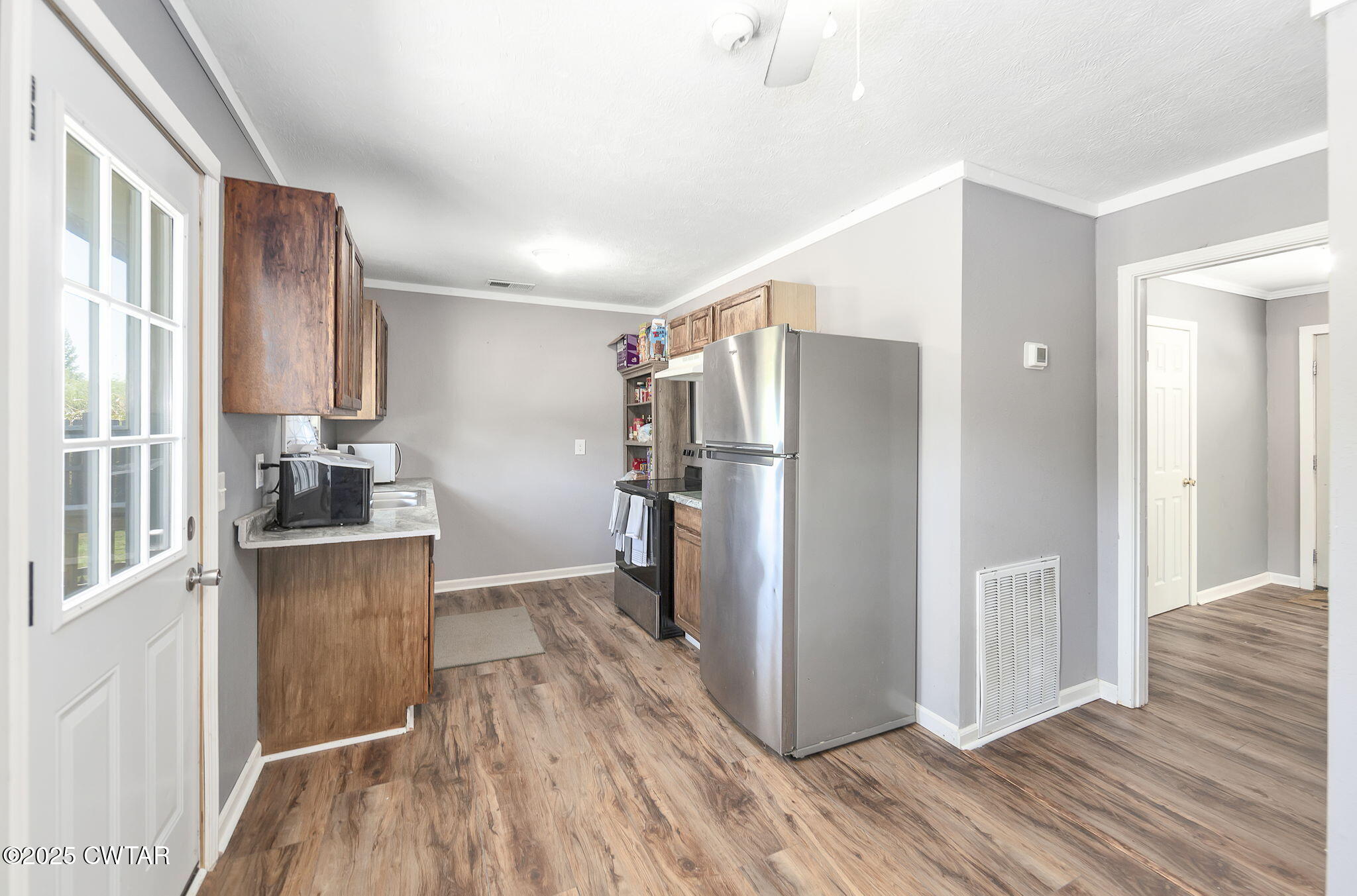 668 Bowman Road Medon, TN 38356 - Photo 9 of 24 a kitchen with a refrigerator and a sink