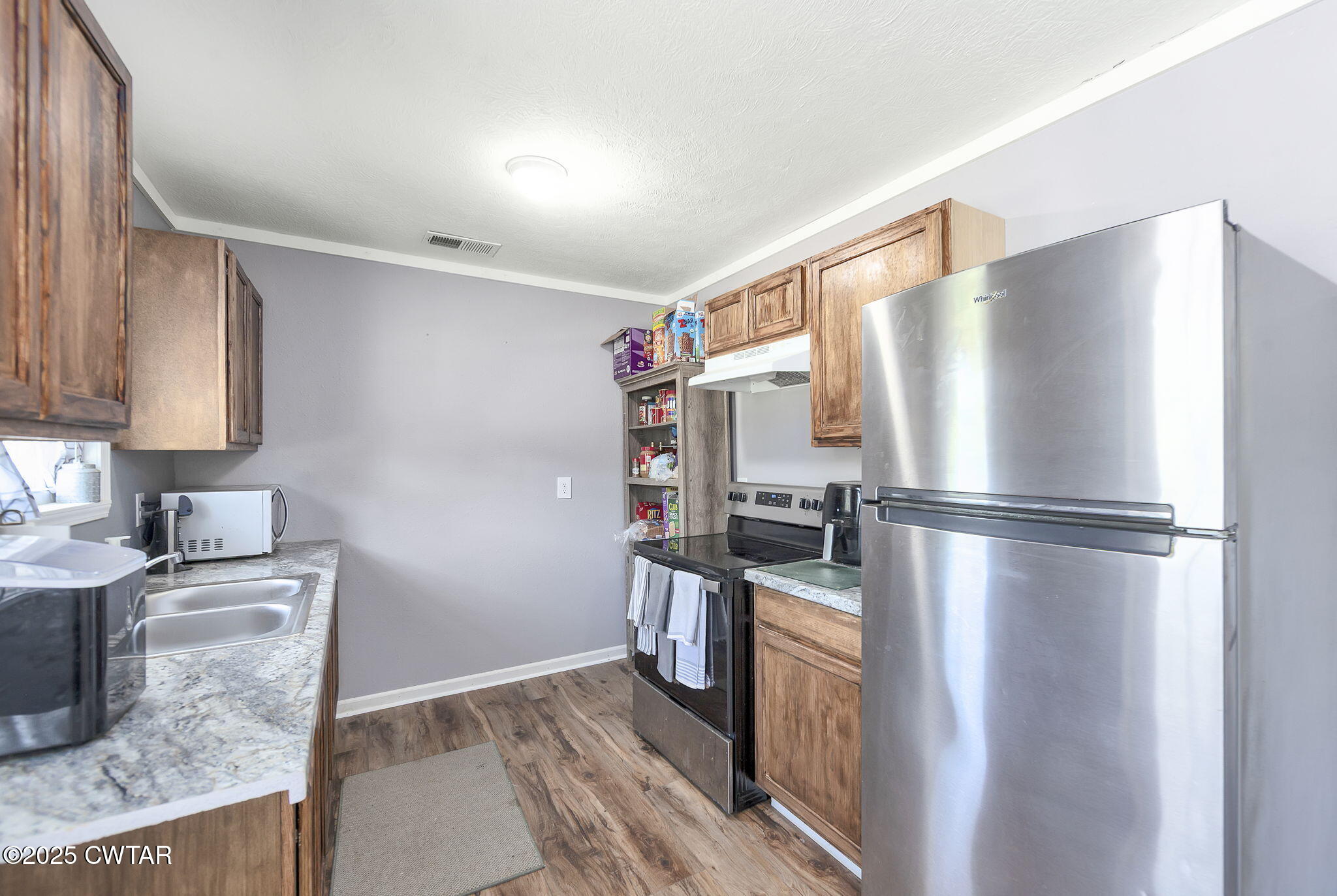 668 Bowman Road Medon, TN 38356 - Photo 10 of 24 a kitchen with stainless steel appliances granite countertop a refrigerator a stove and a sink