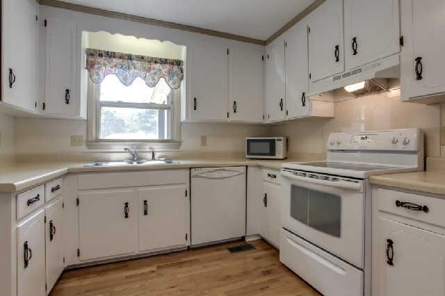 2122 Sulphur Springs Road Murfreesboro, TN 37129 - Photo 6 of 20 Great horseshoe kitchen with freshly painted cabinets, window over the sink looking into the fenced back yard and a smooth top stove