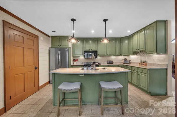 a kitchen with a stove sink and cabinets