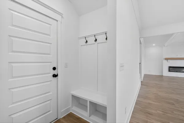 a view of a hallway with wooden floor and staircase