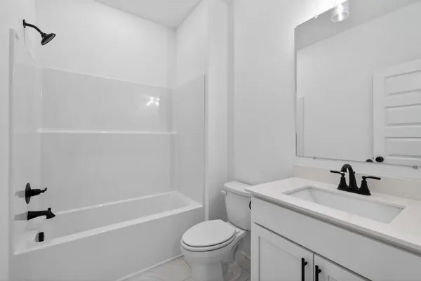 a bathroom with a sink a toilet and a bathtub