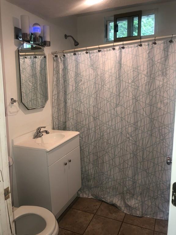 280 Onset Avenue Wareham, MA 02558 - Photo 6 of 15 a bathroom with a sink a toilet and shower curtain