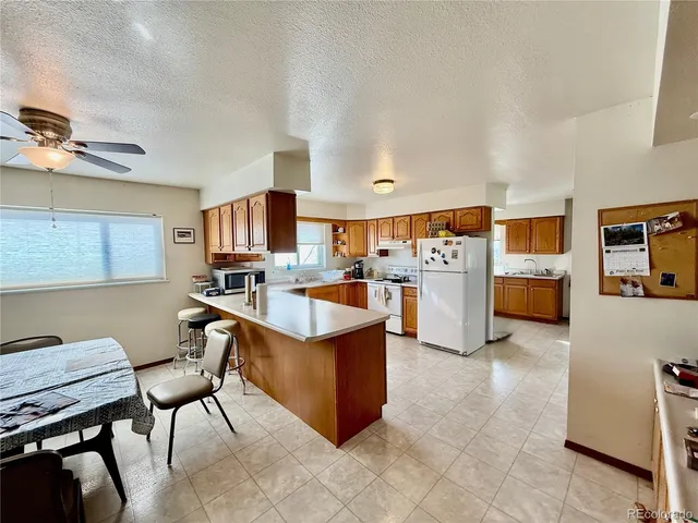 a large white kitchen with lots of counter space and appliances