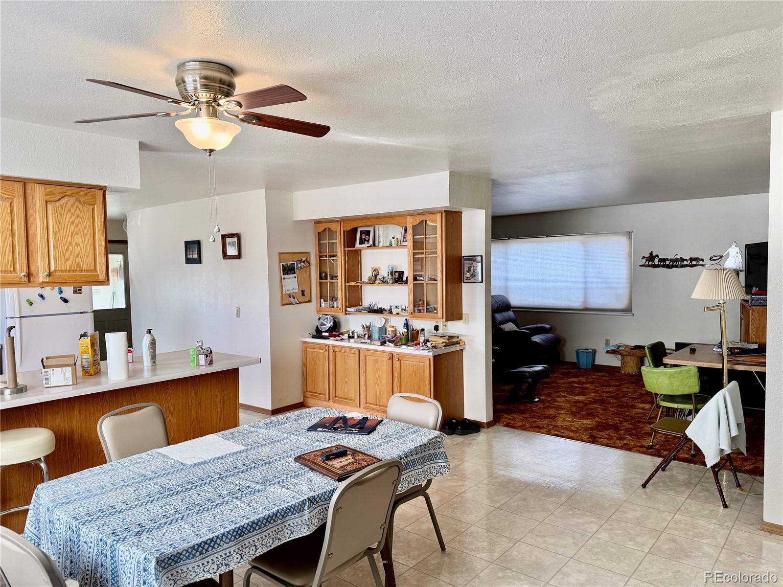 6216 Moreland Road Boone, CO 81025 - Photo 15 of 37 a living room with furniture a chandelier and a dining table