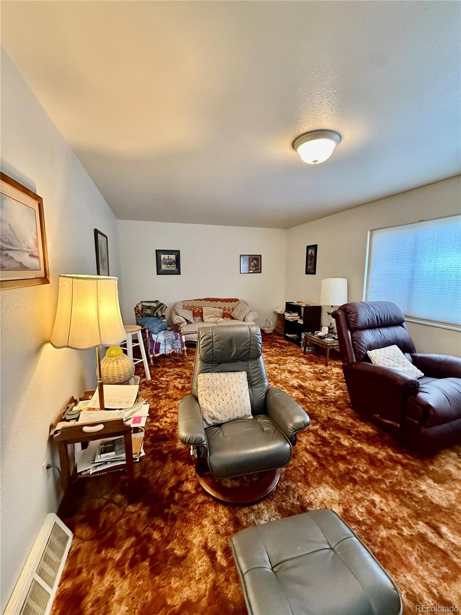 6216 Moreland Road Boone, CO 81025 - Photo 16 of 37 a living room with furniture and a lamp