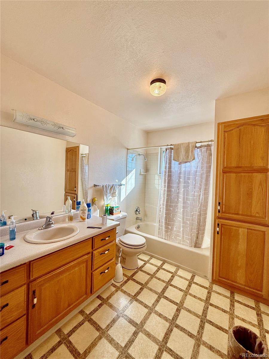 6216 Moreland Road Boone, CO 81025 - Photo 20 of 37 a large bathroom with a double vanity sink a mirror and a shower