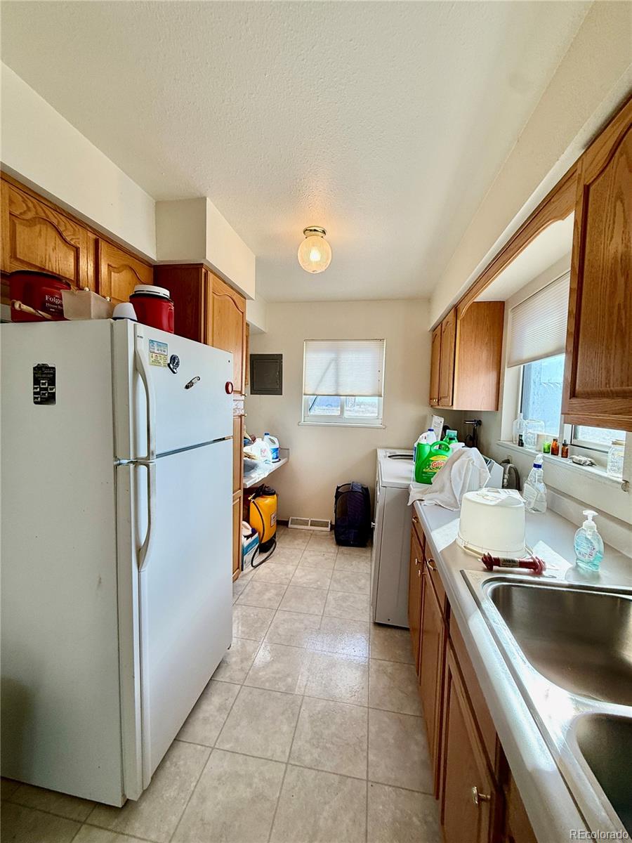 6216 Moreland Road Boone, CO 81025 - Photo 22 of 37 a kitchen with a refrigerator and a sink
